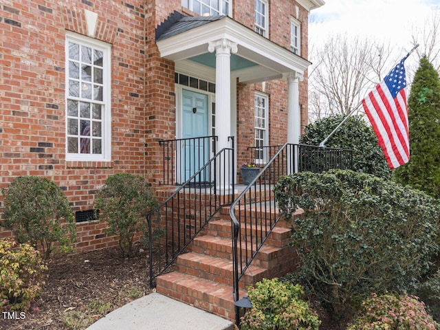 doorway to property with brick siding and crawl space