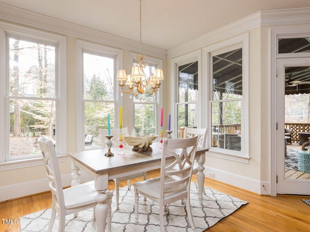 sunroom / solarium with a notable chandelier and a healthy amount of sunlight