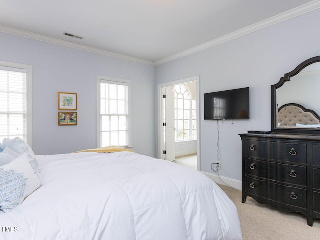 bedroom with visible vents, light colored carpet, crown molding, and baseboards