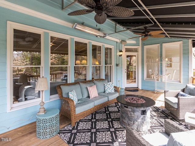 interior space featuring an outdoor living space with a fire pit and ceiling fan