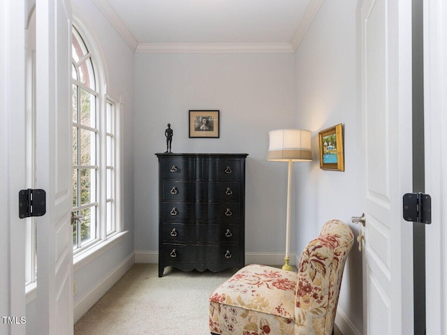 living area featuring baseboards, light carpet, and crown molding