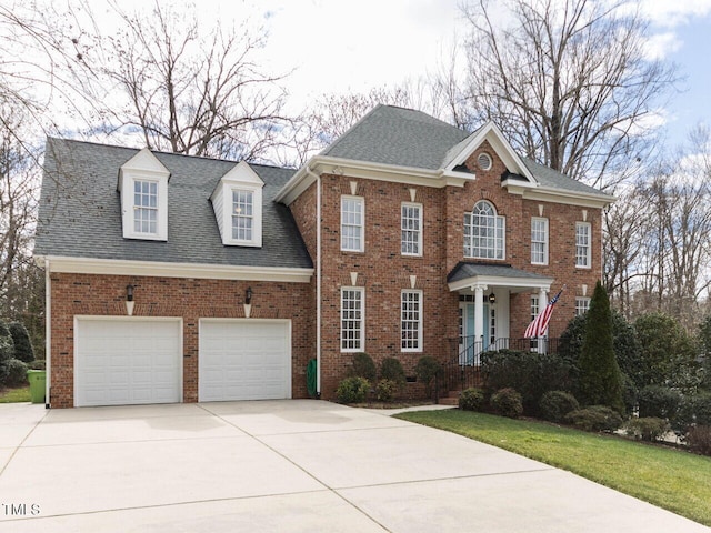 view of front of house with concrete driveway, an attached garage, brick siding, and a shingled roof