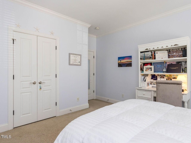 carpeted bedroom featuring a closet, baseboards, and crown molding