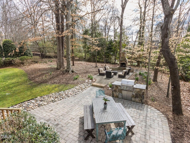 view of patio / terrace featuring outdoor dining space, area for grilling, an outdoor living space with a fireplace, and an outdoor kitchen