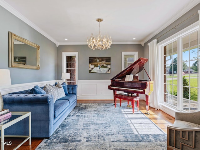 93 Shoreline Dr, Princeton, NC 27569 - living room featuring wood finished floors, a wainscoted wall, recessed lighting, crown molding, and a notable chandelier