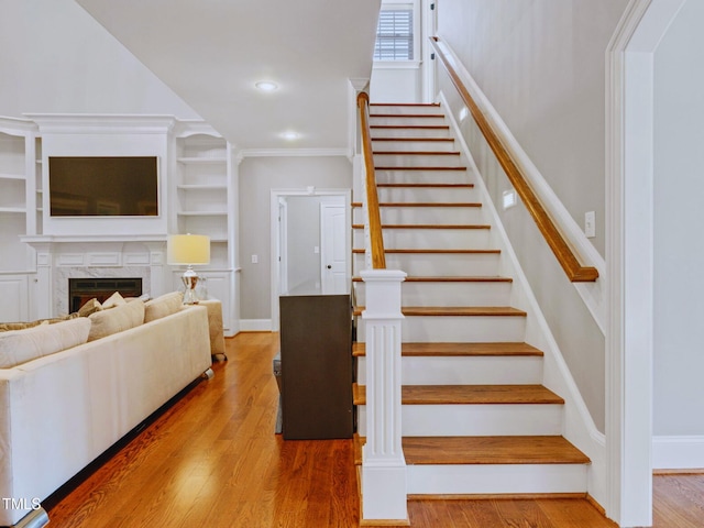 93 Shoreline Dr, Princeton, NC 27569 - staircase featuring a fireplace, crown molding, recessed lighting, and wood finished floors