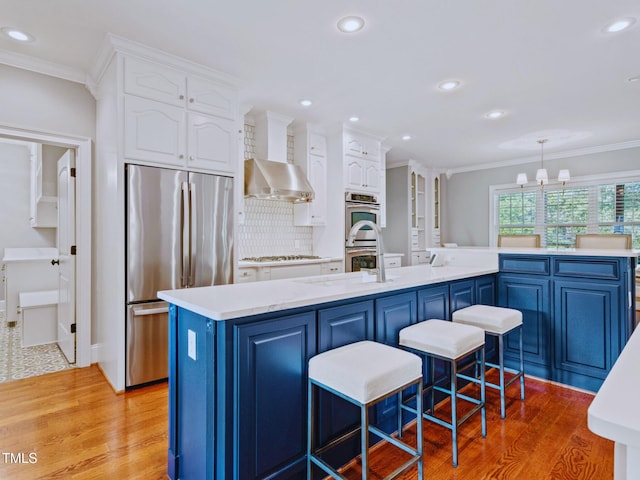 93 Shoreline Dr, Princeton, NC 27569 - kitchen with crown molding, wall chimney range hood, white cabinets, and stainless steel appliances