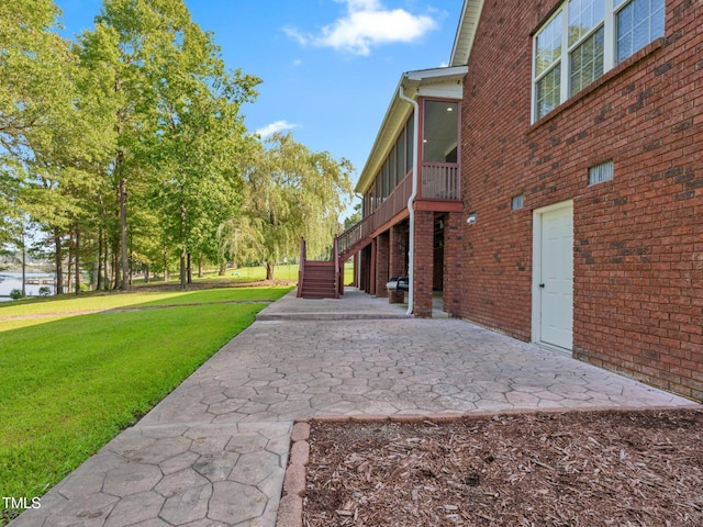 93 Shoreline Dr, Princeton, NC 27569 - exterior space featuring stairway, a yard, brick siding, and a sunroom