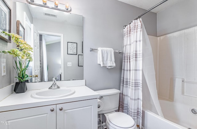 bathroom featuring visible vents, toilet, vanity, shower / bath combination with curtain, and a textured ceiling