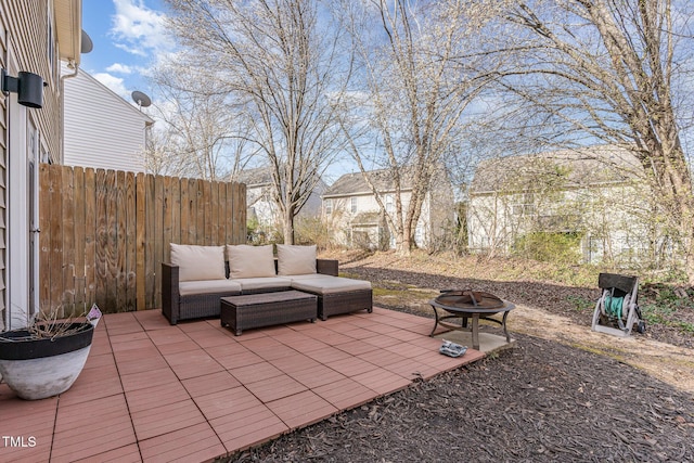 view of patio / terrace with an outdoor living space with a fire pit and fence