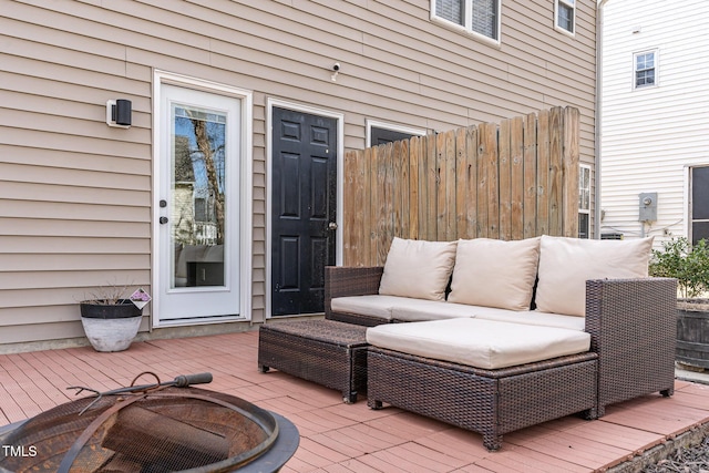 deck with a patio area, an outdoor living space, and fence