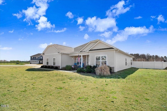 back of property with a yard and fence