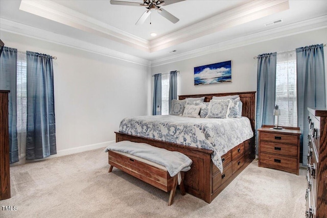 bedroom with visible vents, baseboards, crown molding, a raised ceiling, and light colored carpet