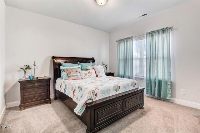 bedroom with visible vents, light carpet, and baseboards