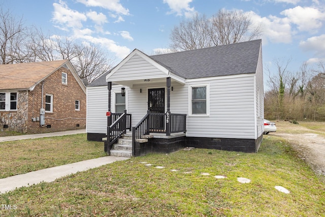 bungalow-style house featuring crawl space, a front lawn, and roof with shingles