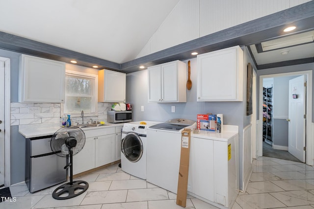 clothes washing area with a sink, recessed lighting, marble finish floor, and washing machine and clothes dryer