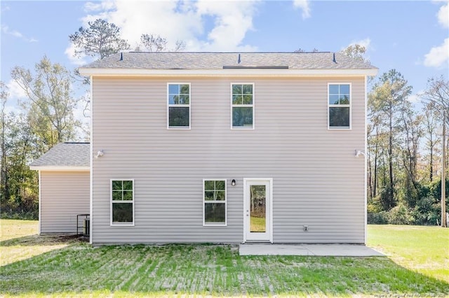 rear view of house with a patio area and a yard