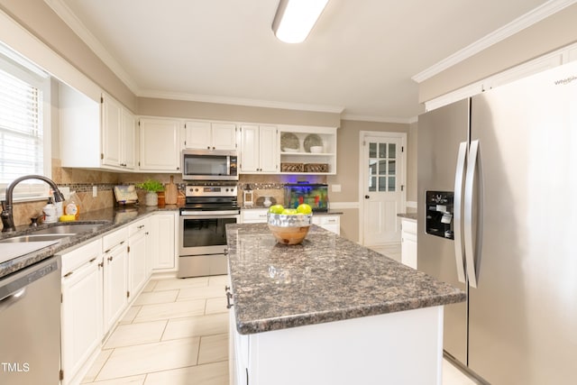 kitchen featuring a sink, a center island, decorative backsplash, stainless steel appliances, and open shelves