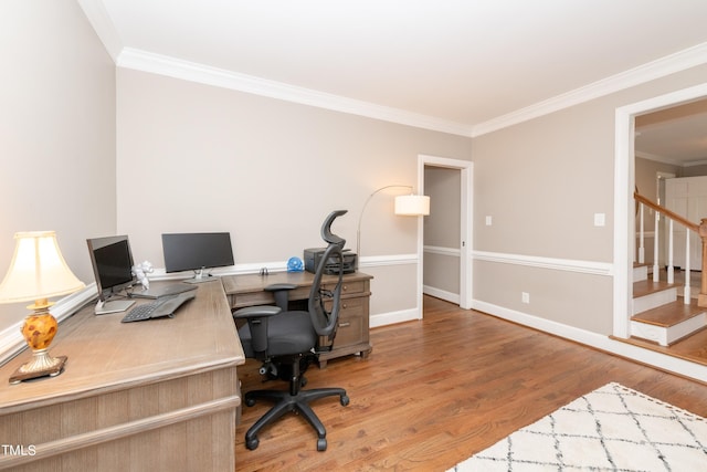 office area featuring baseboards, wood finished floors, and crown molding