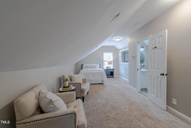 bedroom with vaulted ceiling, baseboards, and light carpet