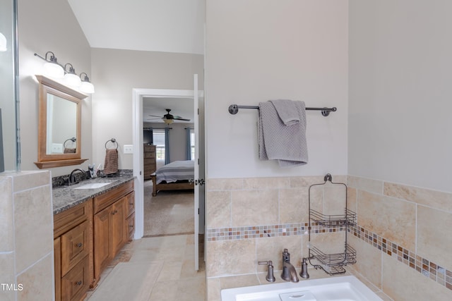 ensuite bathroom featuring vanity, ensuite bath, a tub, and tile patterned floors