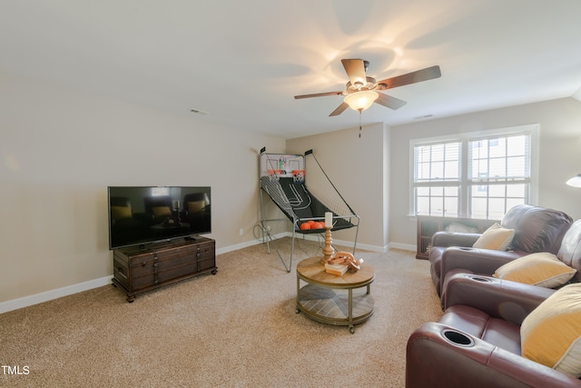 carpeted living area featuring visible vents, baseboards, and ceiling fan