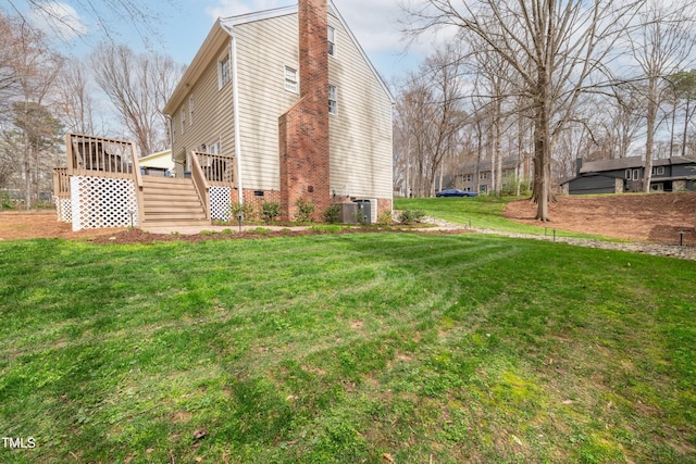 view of home's exterior featuring crawl space, a lawn, a wooden deck, and a chimney