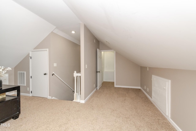 bonus room featuring visible vents, carpet flooring, baseboards, and vaulted ceiling