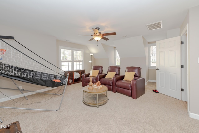 carpeted living area featuring visible vents, plenty of natural light, a ceiling fan, and baseboards