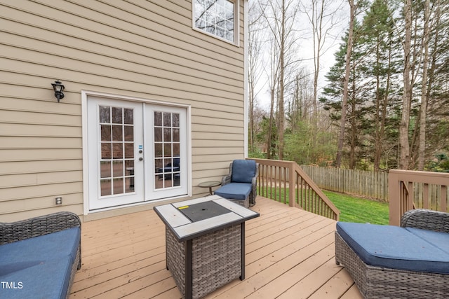 wooden terrace featuring french doors and fence