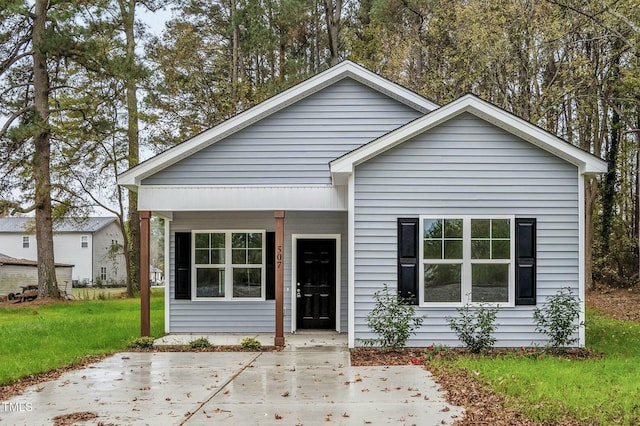 bungalow-style house with a front lawn