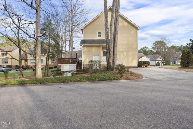 view of front of property featuring a residential view and driveway