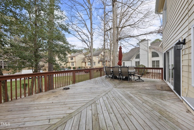 deck featuring outdoor dining space and a residential view