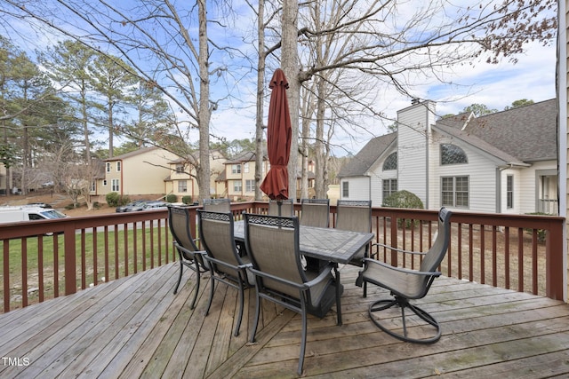 deck with outdoor dining area and a residential view