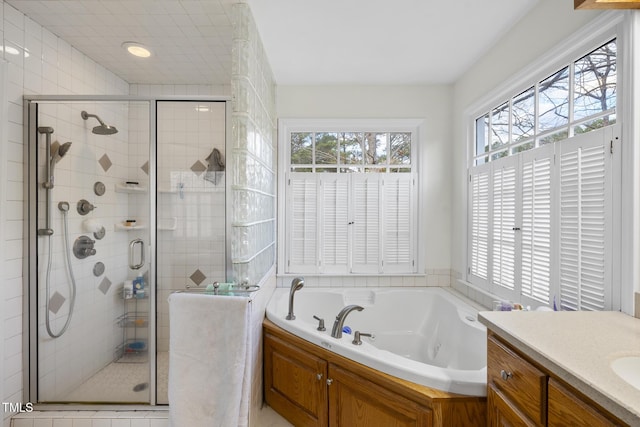 full bath with a garden tub, a stall shower, and vanity