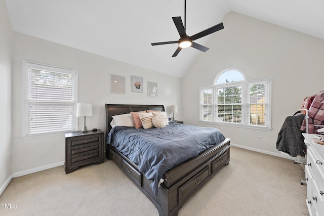 bedroom featuring multiple windows, light carpet, baseboards, and ceiling fan