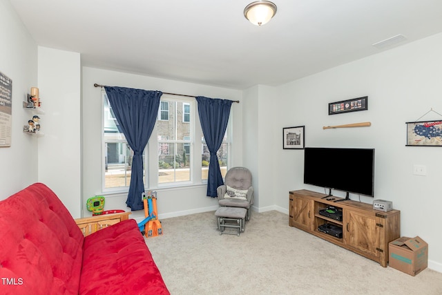 living area with visible vents, baseboards, and carpet