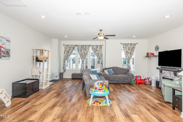 living room with recessed lighting, visible vents, light wood-style flooring, and a ceiling fan