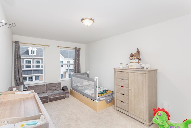 bedroom featuring light carpet