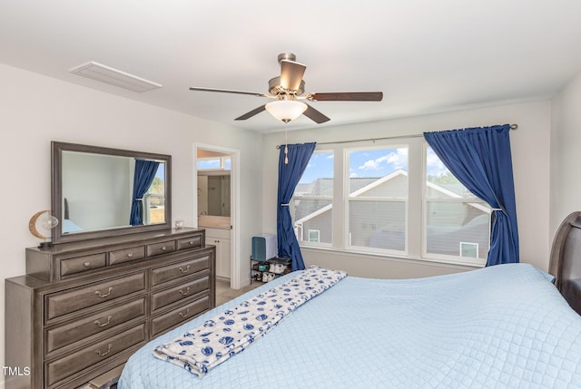 bedroom with visible vents, connected bathroom, and a ceiling fan