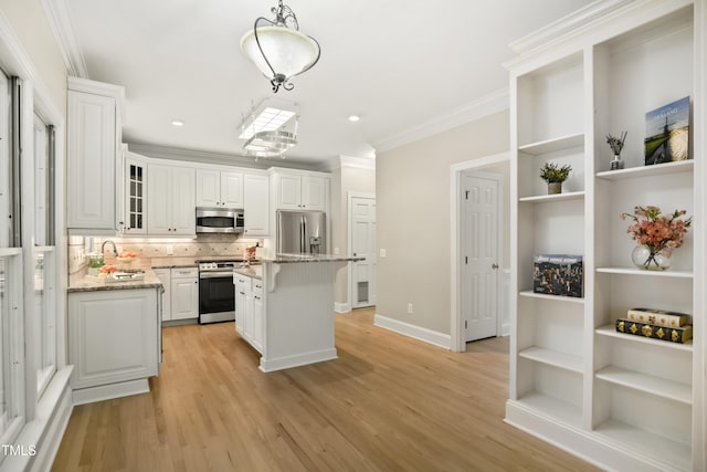 kitchen with light wood-style flooring, open shelves, appliances with stainless steel finishes, white cabinets, and crown molding