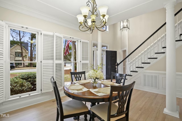 dining area featuring stairway, visible vents, ornamental molding, a notable chandelier, and light wood-type flooring