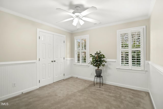 unfurnished bedroom with a closet, carpet floors, and wainscoting