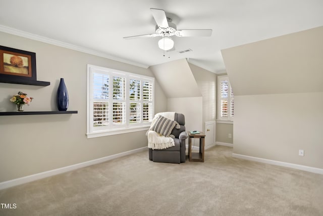 sitting room featuring a ceiling fan, baseboards, carpet floors, and ornamental molding