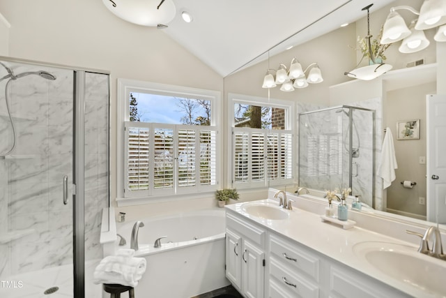 bathroom with lofted ceiling, a garden tub, a stall shower, and a sink