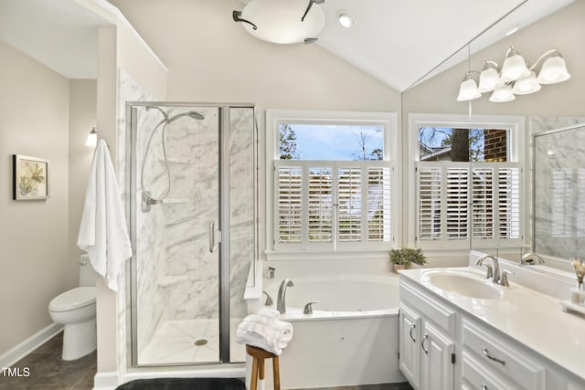 bathroom featuring vanity, a bath, a stall shower, vaulted ceiling, and toilet