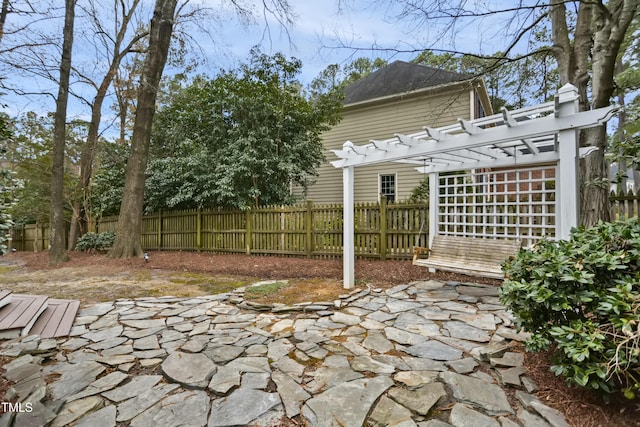 view of patio featuring a pergola and fence