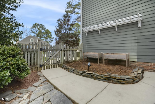 view of patio with a gate and fence