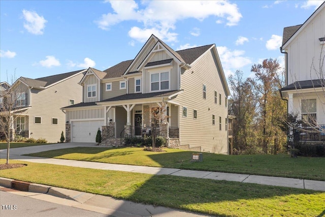 craftsman-style home featuring a front lawn, a porch, board and batten siding, and driveway