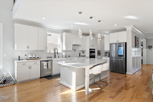 kitchen with white cabinetry, stainless steel appliances, crown molding, light countertops, and decorative backsplash